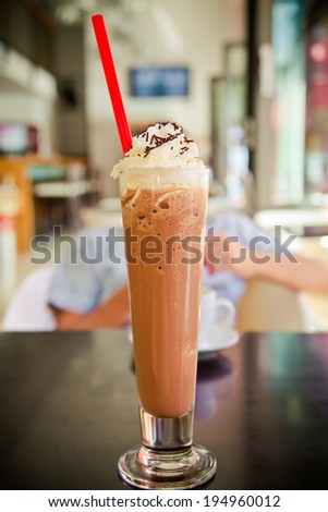 close-up glass with iced coffee blended with cream