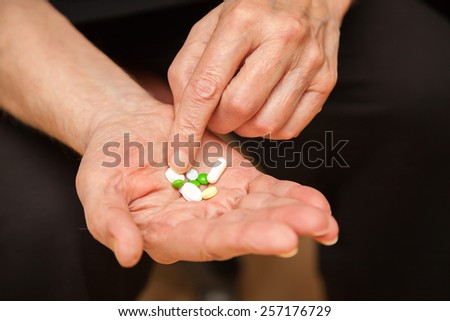 close-up old man\'s hands with pills
