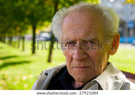 face portrait of an old displeased senior