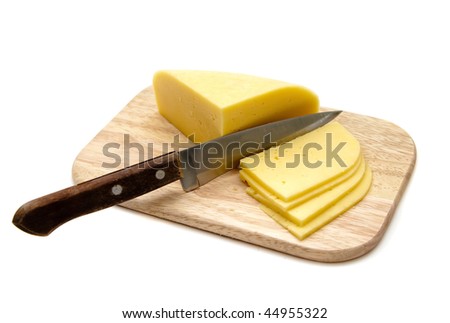 block of cheese with cut pieces on cutting board with a knife, isolated on white background