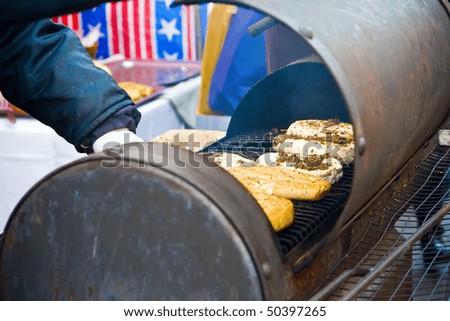 a human making a smoked cheese outdoors