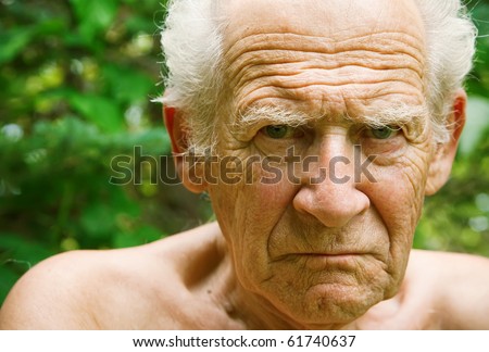 face portrait of an old angry frowning senior man