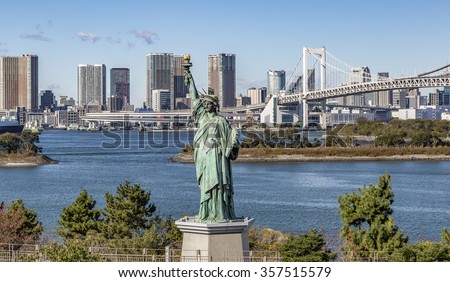 TOKYO, JAPAN - NOVEMBER 26, 2015: Odaiba Statue of Liberty on the background of Tokyo skyline.