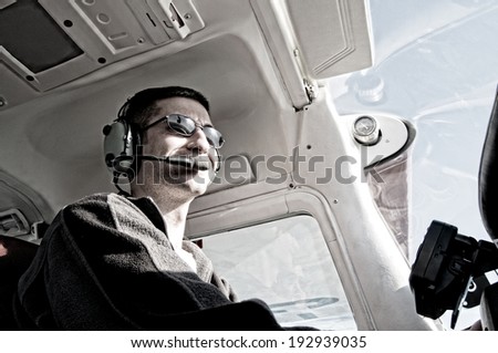 Low-angle view of pilot in cockpit of single-engine aircraft