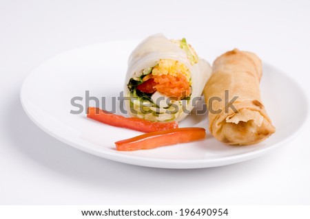A sushi roll, a fried egg roll, and red bell pepper strips on a plate.