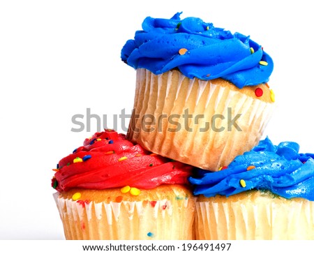 Two blue and one red cupcake, stacked on top of each other.