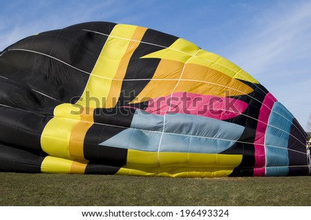 A hot air balloon that is starting to be inflated.