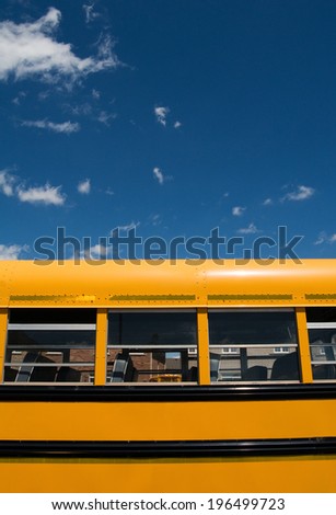 Side view of several windows on an empty school bus.