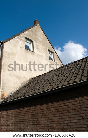 Clay tiles cascading down the pitch of a steep roof.