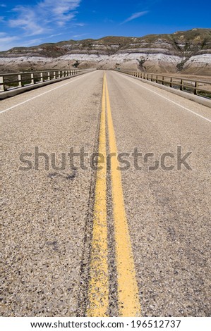 A road with a yellow line that goes off into the distance.