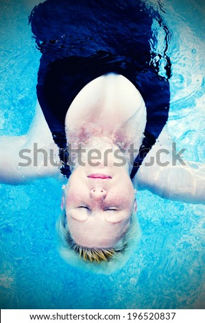 A woman floating in a pool of water.