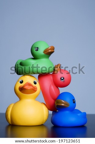 Four rubber ducks piled on top of each other.