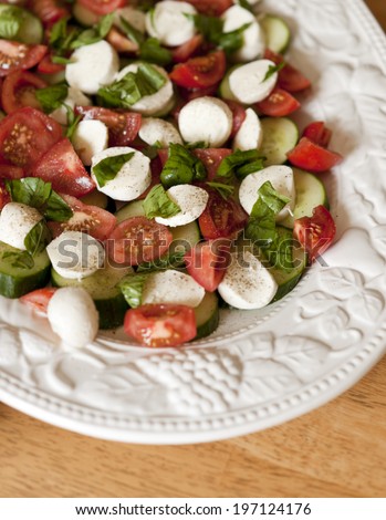 A plate of vegetables arranged on a white plate.