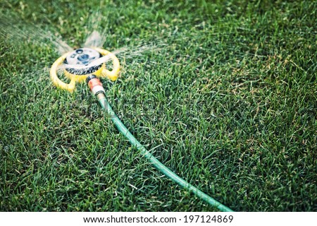 A sprinkler system spraying water on a lawn.
