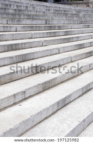 Numerous grey concrete steps in a stacked row.