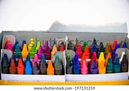 A cardboard box of different colored crayons, all sharpened.