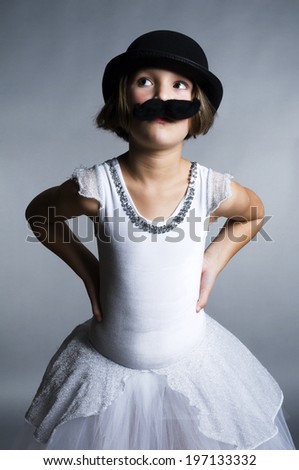 A young girl wearing a mustache and a hat.