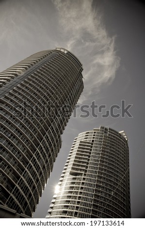 Two tall round buildings with lots of windows.