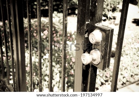 Double locks on a gate door outside the house.