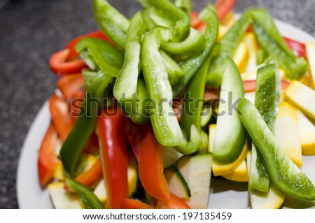 A variety of colorful peppers piled together on a dish.