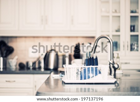 A kitchen countertop and a sink with dishes.