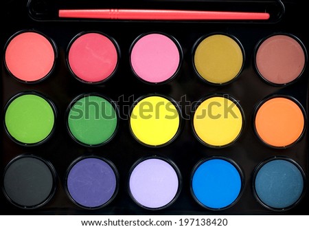 High angle of water color paints in a black tray.