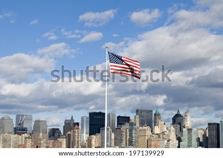 The American flag in front of a city skyline.
