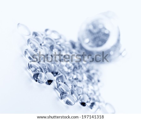 Clear glass beads sitting on a white hard surface.