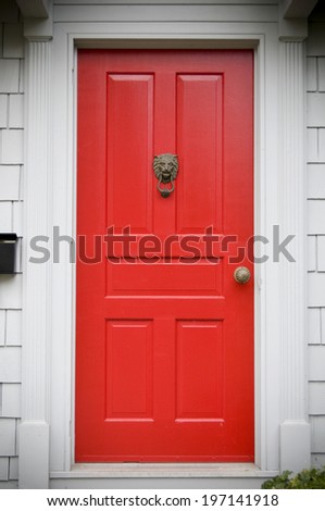 A red door in a white wall at eye-level