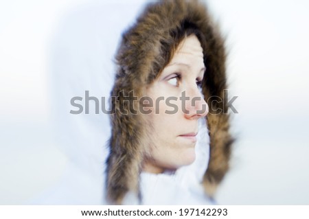 A woman in a white parka with brown fur.