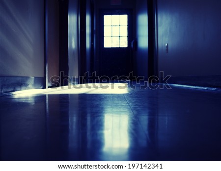 A blue floor, door and walls inside a building.