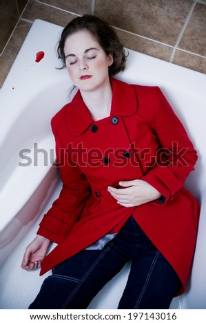 A woman in a red jacket lays in a tub with a small blood puddle.
