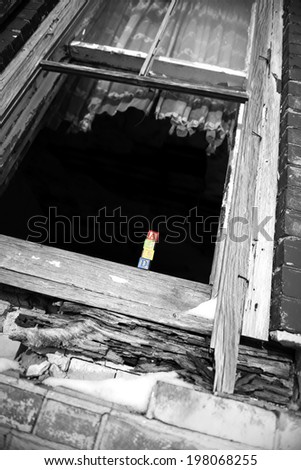 An open window with a child\'s building blocks sitting in the window sill.