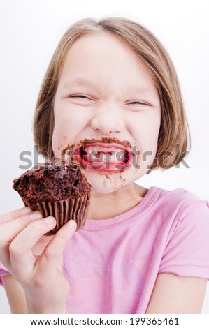 Girl eating cupcake messily