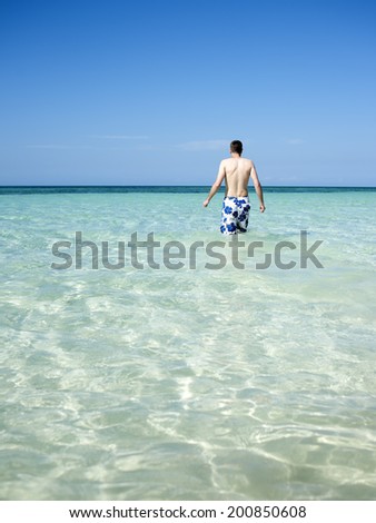 Man wading in sea