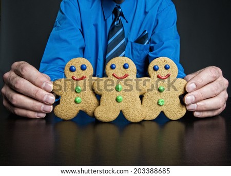Man holding up gingerbread cookies