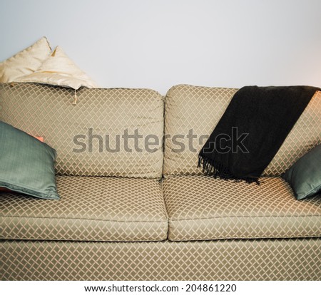 Green and gold couch with cushions