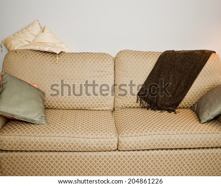 Gold and green couch with cushions