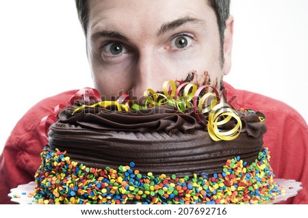 Man burying face in chocolate cake