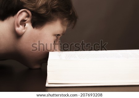 Boy with his nose in a book