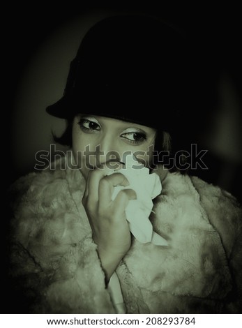 Woman dressed as flapper wiping away tears
