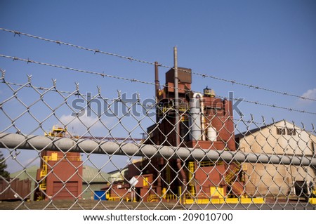 Factory behind barbed wire fence