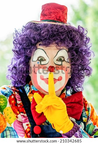 A pretty clown performs in a variety of stunts and poses.