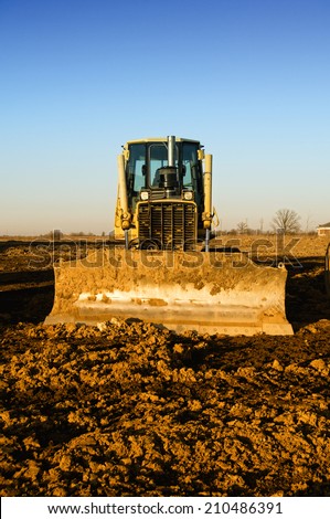 Bulldozer with dirt-encrusted blade