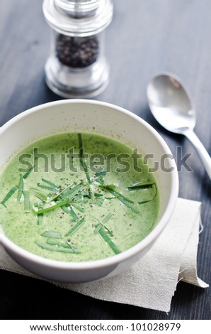 a cup of wild garlic soup with fresh wild garlic