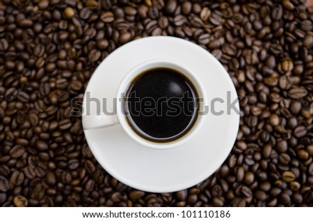 Coffee cup on a lot of coffee beans