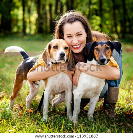 beautiful woman and his dogs posing outside