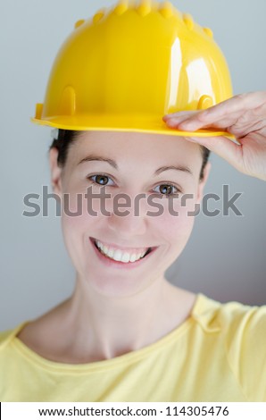 Portrait of attractive smiling architect girl with hard hat