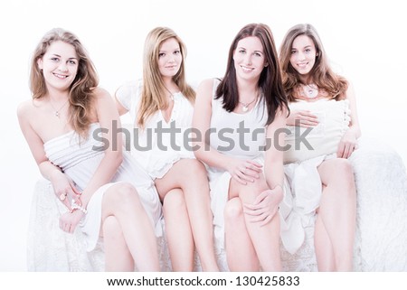 Group of four sexy, beautiful young happy women. Isolated on white