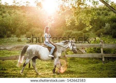 Woman getting ready for horseback riding